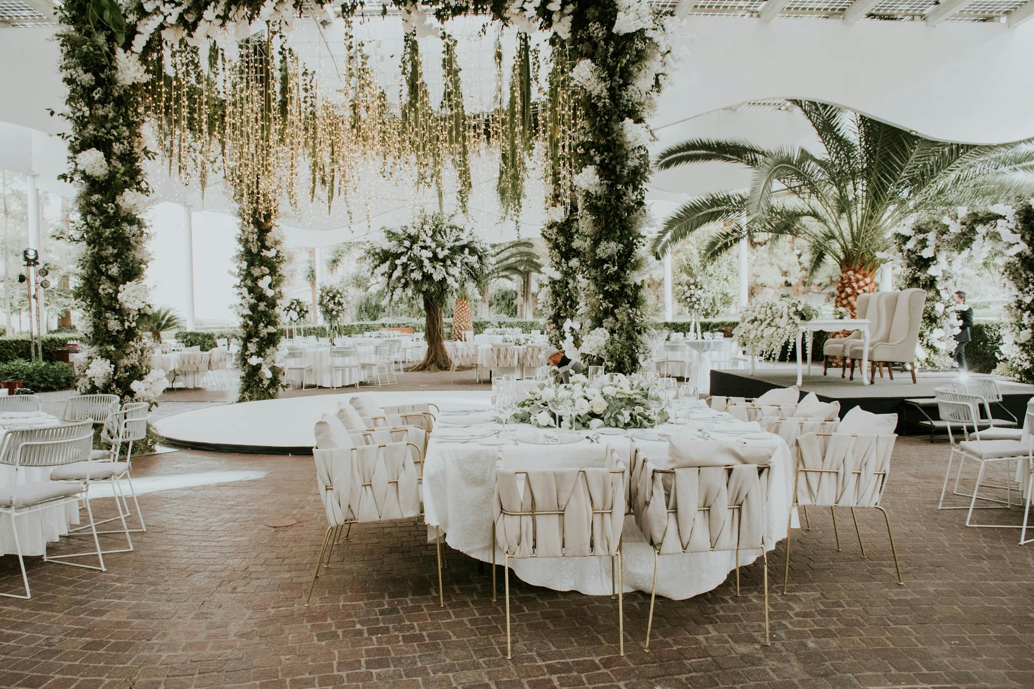 Stunning outdoor wedding setup featuring floral decorations, elegant seating, and ambient lighting.